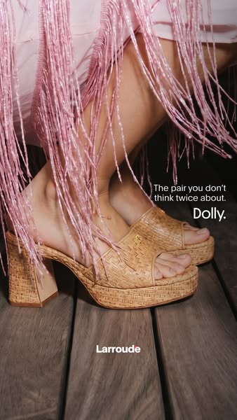 This image ad for Larroude shoes features the Dolly platform sandal and emphasizes the ease and style of the shoe.