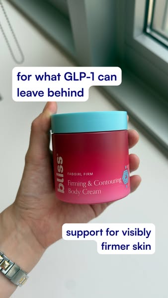This Bliss ad shows a hand holding a jar of FABGIRL FIRM Firming & Contouring Body Cream, with the text overlay '