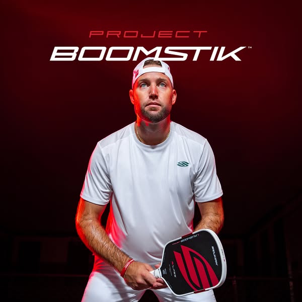This ad features a pickleball athlete holding a Selkirk PROJECT BOOMSTIK paddle. The ad highlights the paddle's desi