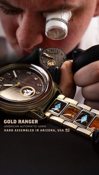 This ad features a close-up of a watchmaker working on a 'Gold Ranger' watch, highlighting the hand-assembled as