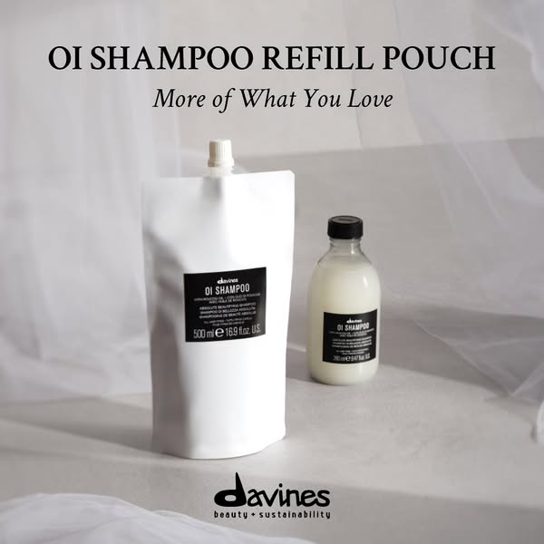 A product shot featuring Davines OI Shampoo in both its original bottle and a refill pouch, highlighting environmental c