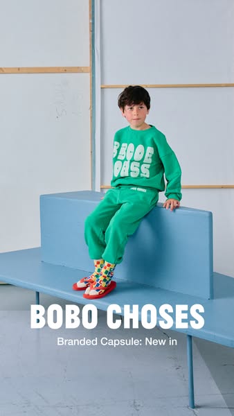 This image ad showcases the new Bobo Choses branded capsule collection, featuring a child model wearing a green sweatsui