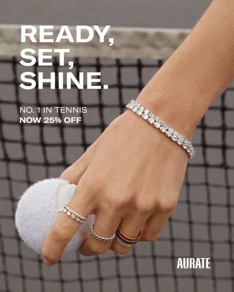 This image ad for Aurate jewelry features a woman's hand holding a tennis ball, adorned with a diamond bracelet and 