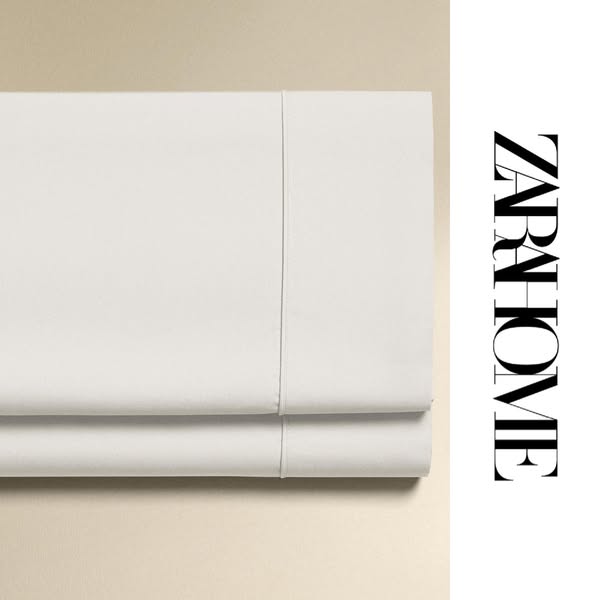 This ad showcases a neatly folded white Zara Home sheet set.