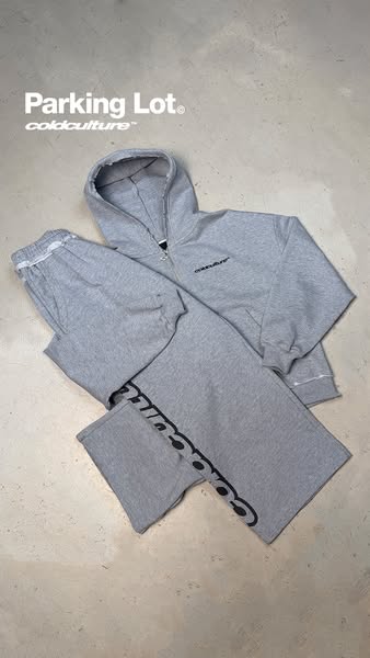 This ad showcases a matching grey hoodie and sweatpants set. The brand name is prominently displayed in the upper left o
