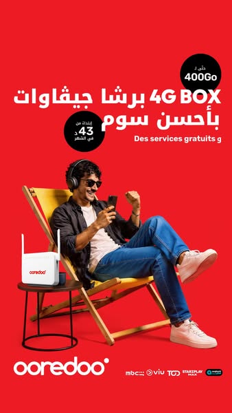 This image ad for Ooredoo features a relaxed man using his phone in a beach setting, highlighting the benefits of their 