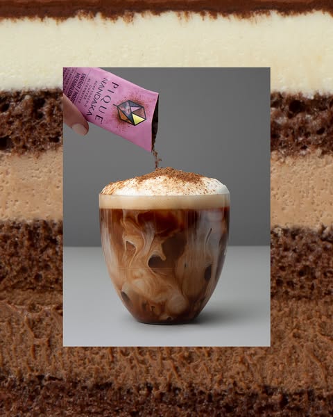 This ad features a close-up shot of a glass filled with a beverage, with a hand pouring the contents of a Pique Nandaka 