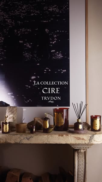 This ad is for Cire Trudon candles and home fragrances and shows several of the products arranged on a mantelpiece.
