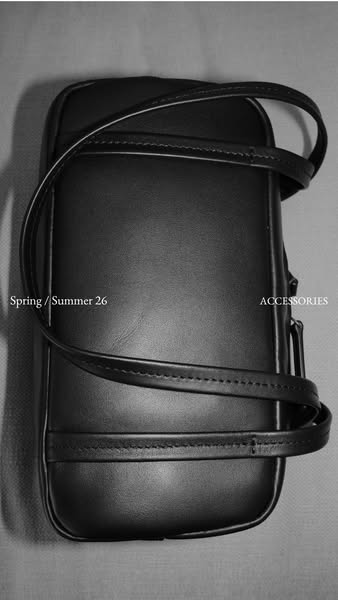 This image promotes a sleek and modern black bag, highlighted with minimalist design elements and a focus on the accesso