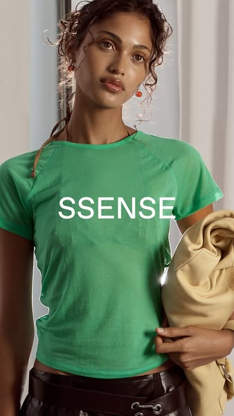 An image ad for SSENSE features a model wearing a green t-shirt with the brand name overlaid on the product. It highligh