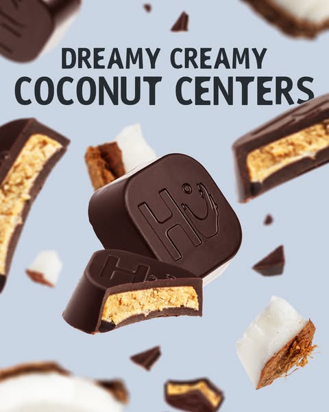 This ad features Hu chocolate coconut butter filled chocolates. The chocolates and pieces of coconut are floating agains