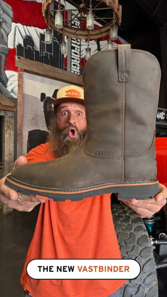 This image ad features a man holding up a work boot, seemingly excited to show it off. Text at the bottom of the image i