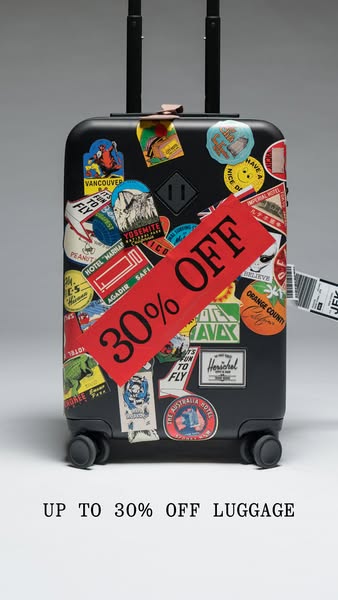 This image ad promotes luggage, offering a discount of up to 30% off. The ad features a black carry-on suitcase covered 
