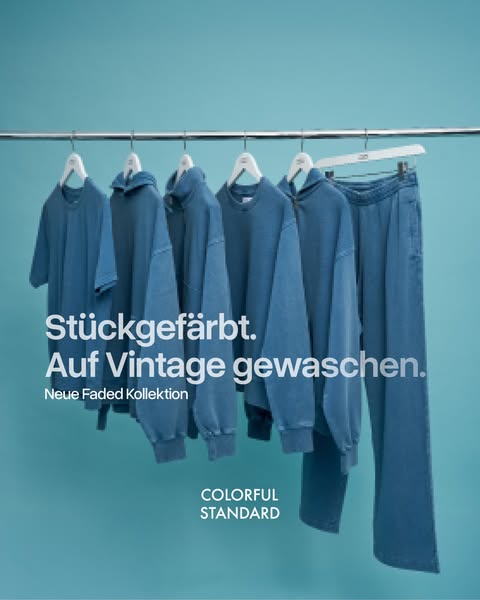 This image ad presents a collection of blue apparel by Colorful Standard, emphasizing its unique dyeing and washing proc