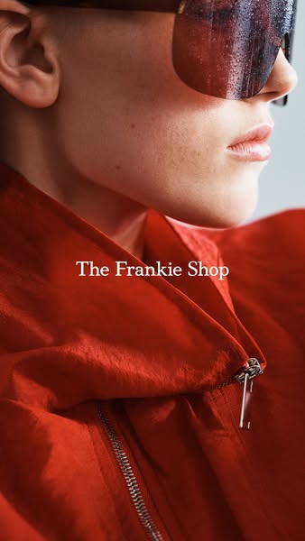 A close-up shot showcases the stylish design and texture of a red jacket from The Frankie Shop, paired with reflective s