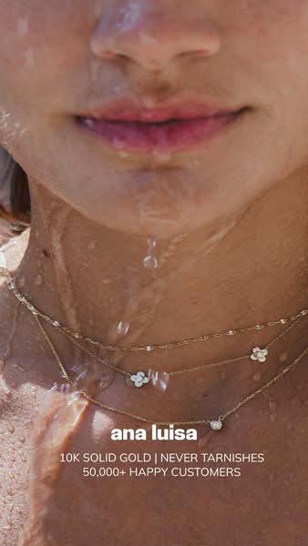 This Ana Luisa ad features a close-up shot of a model's neck and chest wearing three of the brand's gold necklac
