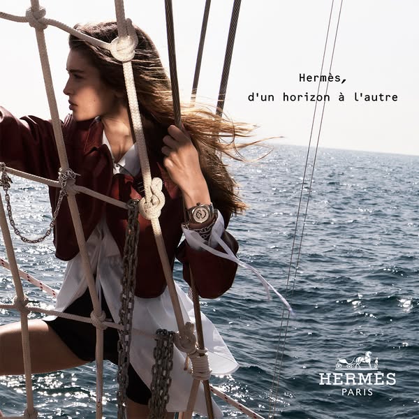 This ad features a woman on a boat wearing a Hermès watch. The ad is designed to evoke feelings of luxury and adventure.