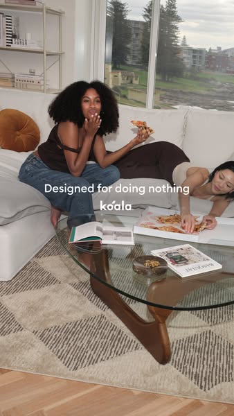This image ad for Koala features two young women relaxing on a couch and eating pizza to promote Koala's furniture a
