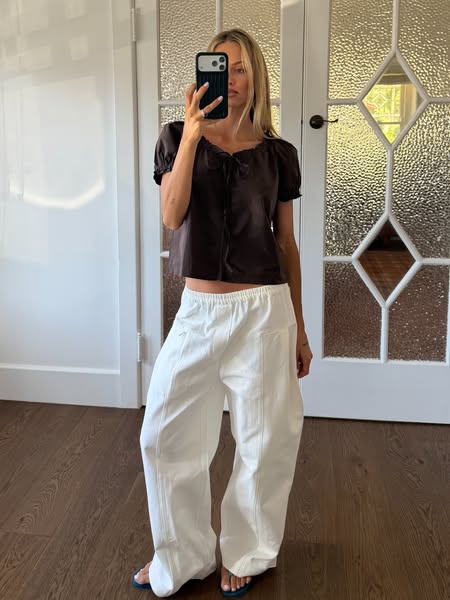 A woman is posing in clothing from the brand.