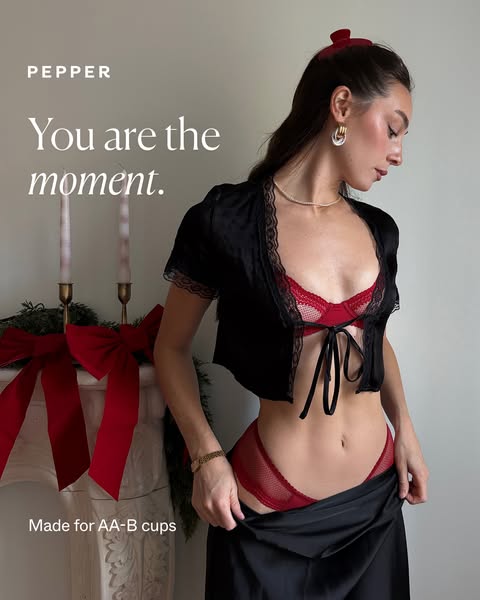 This image ad for Pepper lingerie features a woman wearing a red bra and panty set with a black top and skirt. The ad hi