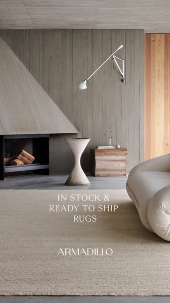 This ad for Armadillo rugs showcases a beige woven rug in a minimalist space with a fireplace and modern decor. The ad c