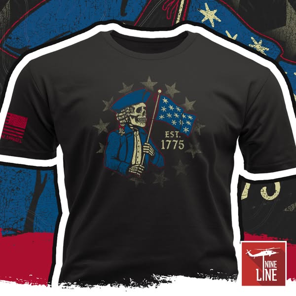 This ad features a black t-shirt with white trim, showing an image of a skeletal revolutionary war patriot holding a fla