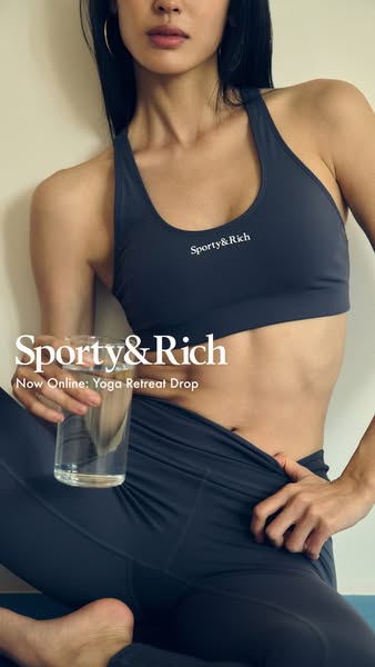 An ad for Sporty & Rich yoga apparel featuring a woman seated cross-legged while holding a glass of water.
