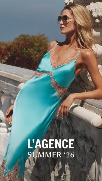 An image ad for L'Agence promotes its Summer '26 collection featuring a model wearing a turquoise satin slip dre