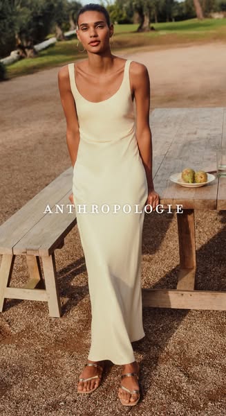 The ad features a tan-skinned woman in her 20s, standing outdoors in a cream-colored dress. The brand name, Anthropologi