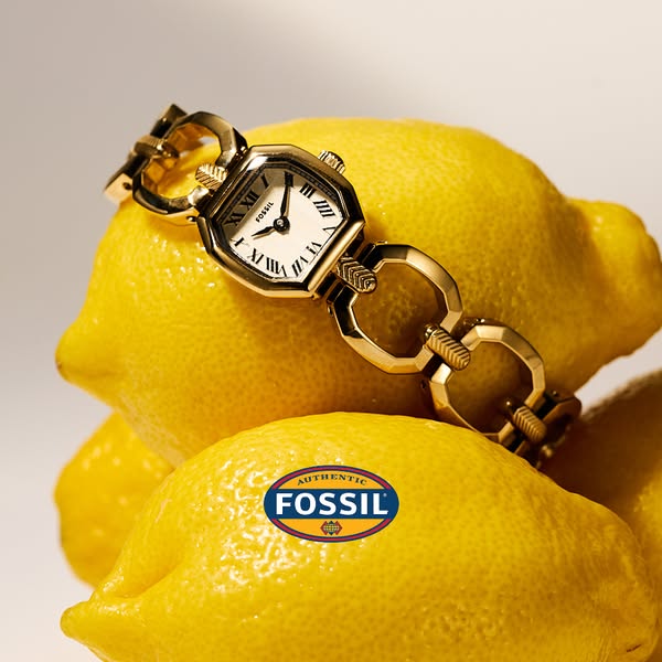 This ad for Fossil features a gold watch displayed on top of a stack of lemons.