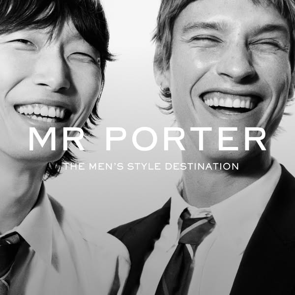 This ad showcases the MR PORTER brand, a men's style destination, through a black and white image of two smiling men