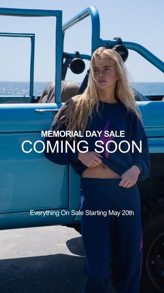 This image ad promotes a Memorial Day sale coming soon. The ad features a model wearing a matching navy blue sweatsuit w