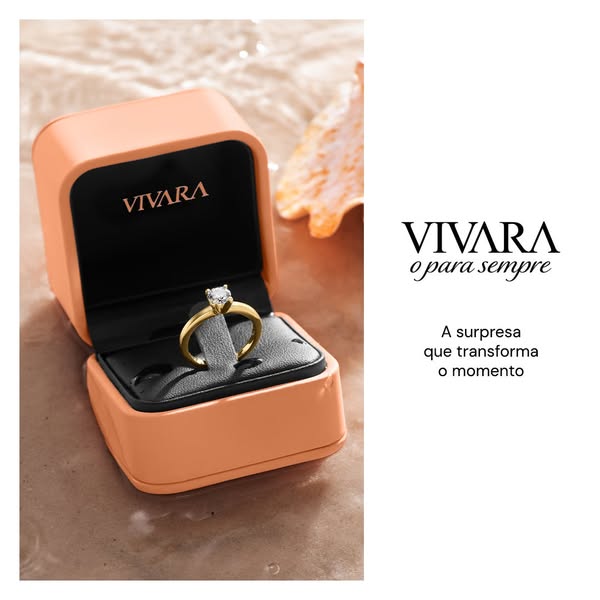 This ad for Vivara showcases a gold ring with a diamond in a peach colored box. The background is blurred to give the ri