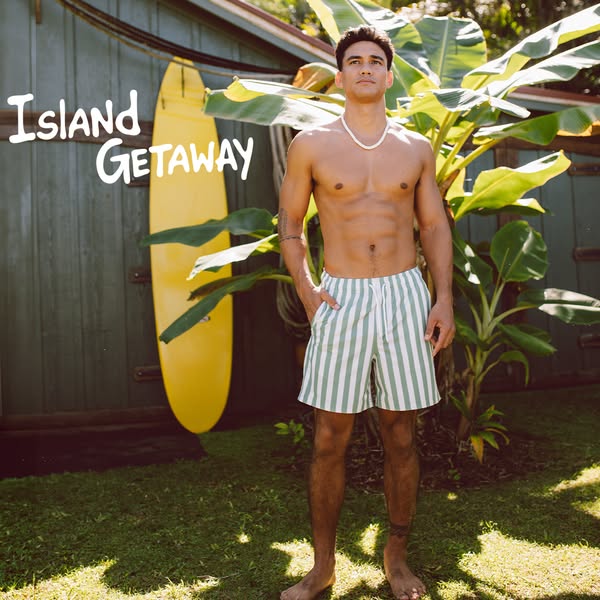 This ad showcases a man standing in front of tropical foliage wearing a pair of men's swim trunks. The ad is bright 