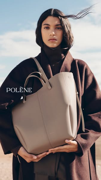 This Polène ad features a model in a desert-like location holding the Cyme Mini bag in a neutral color. The ad emphasize