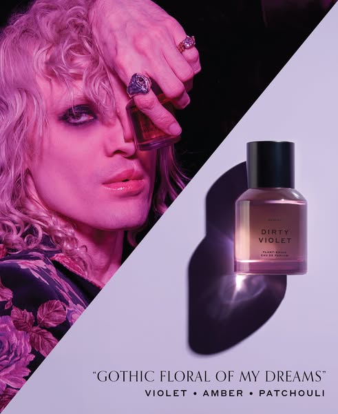 This ad for Heretic Dirty Violet perfume features a gender-neutral model holding the perfume bottle in their hand.