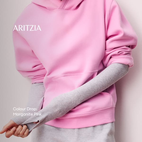 This ad features a light pink hoodie from Aritzia and showcases its new color, Morganite Pink.