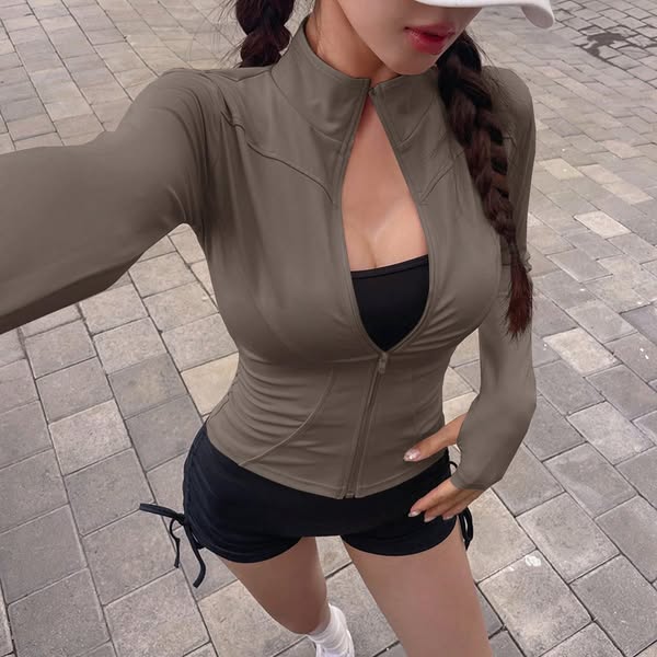 This ad features a woman wearing a form-fitting athletic jacket and shorts, showcasing the fit and style of the activewe