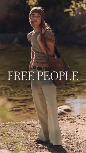 This ad features a woman in Free People clothing standing in a natural setting. The ad promotes the Free People brand.