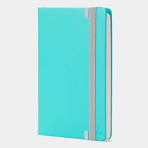This ad features a single product shot of a teal-colored notebook with a gray elastic band. The notebook is displayed ag