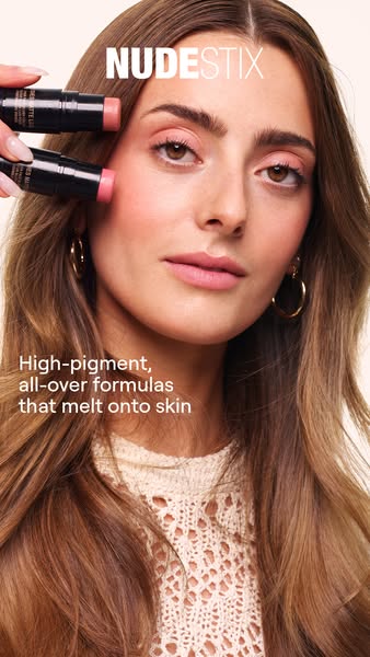 This ad for Nudestix features a close-up of a woman's face with two Nudestix products being held up to her cheek and