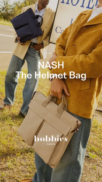 This ad features two men standing outside a hotel, each holding a Bobbies Paris "Nash The Helmet Bag".