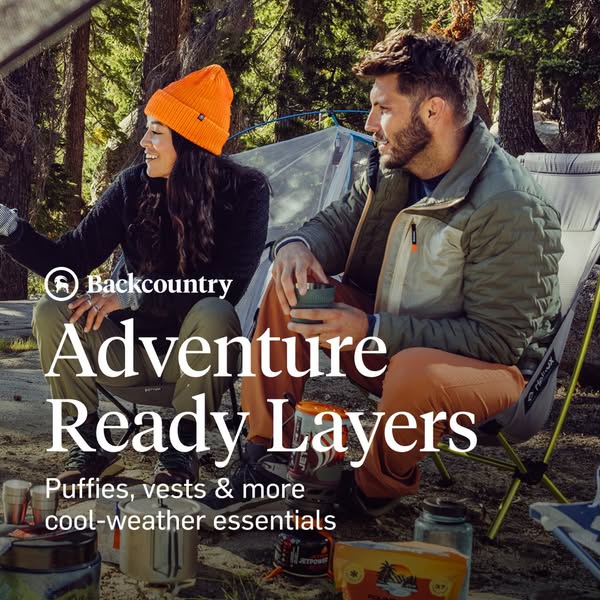 This image ad for Backcountry promotes adventure-ready layers for cool-weather essentials. It features a man and woman c