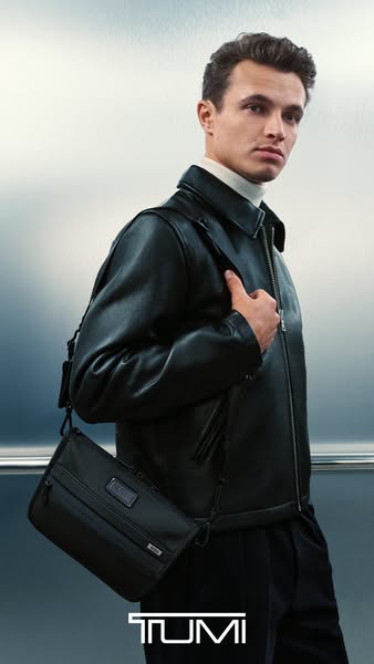 This Tumi ad features a model wearing a black leather jacket and dark pants, with a Tumi bag slung across his torso. The