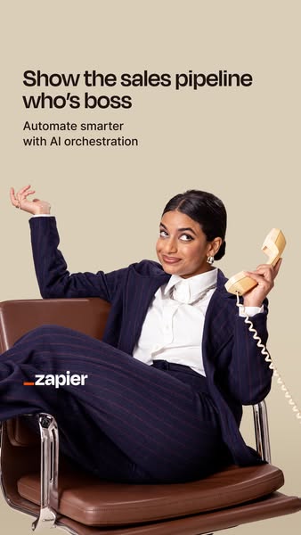This image ad for Zapier features a woman in a business suit sitting in a chair and holding a telephone receiver. The ad