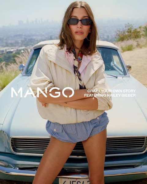 This image ad features Hailey Bieber posing in front of a vintage car wearing clothing from Mango. The ad promotes Mango