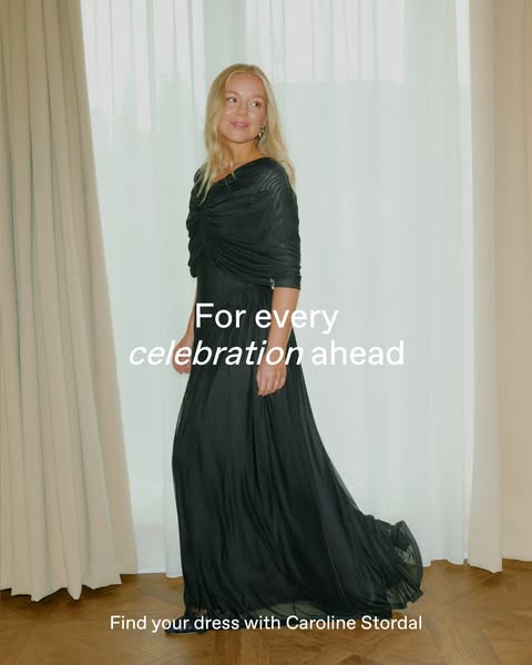 This image ad for Caroline Stordal features a woman in a long, flowing black gown, positioned in front of a window with 