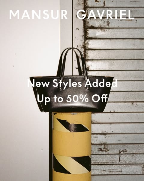This image ad showcases a black Mansur Gavriel tote bag on top of a yellow bollard with a white background on the left a