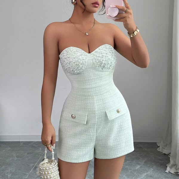 This ad features a woman taking a selfie in a light green strapless romper. The romper has a tweed texture and is embell