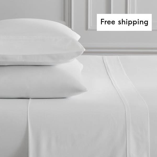 This ad features a close-up of a neatly made bed with white sheets and pillows, emphasizing the comfort and cleanliness 